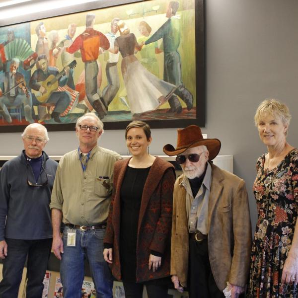 Centenarian artist Lynn Wolfe (fourth from the right) came to see his artwork in the re-opened music library. Also pictured are Stephanie Bonjack, Carl Stewart and two of Wolfe’s relatives. Photo courtesy of University Libraries.