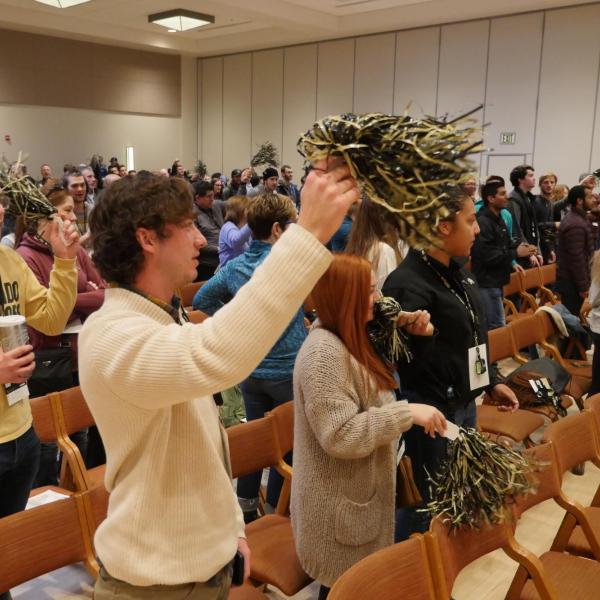 Incoming students shake pompoms during the spring 2018 New Student Welcome Day.