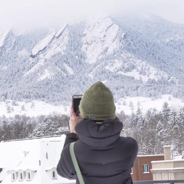 CU Boulder 2011 alumna Meghan Byrne snaps some frames of the snow-covered Flatirons. Photo by Patrick Campbell.