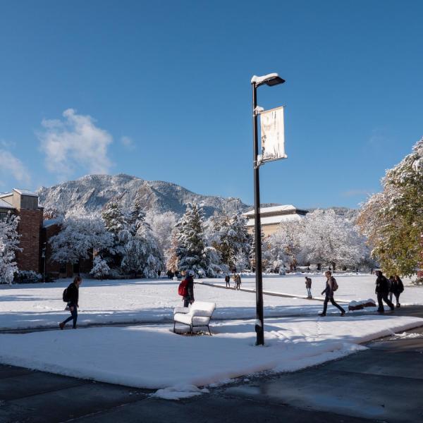 Students walk across a snowy CU Boulder campus after a snowstorm on Oct. 30, 2019. (Photo by Patrick Campbell/University of Colorado)