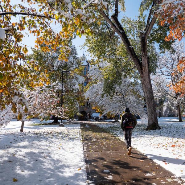 Students walk across a snowy CU Boulder campus after a snowstorm on Oct. 30, 2019. (Photo by Patrick Campbell/University of Colorado)