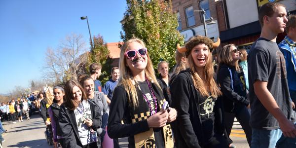 Student walk in the Homecoming parade