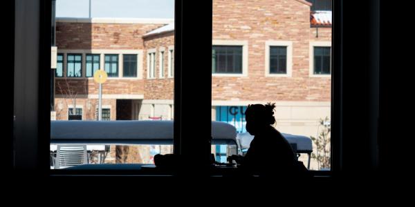 silhouette of a student studying in the CASE building