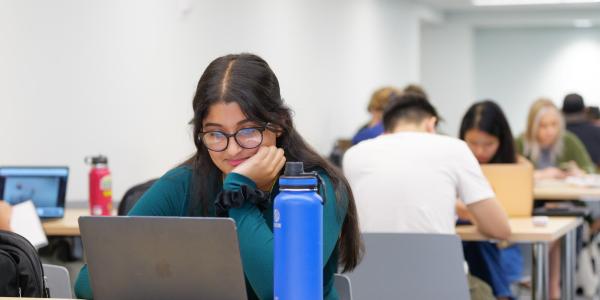 People working on laptops on campus