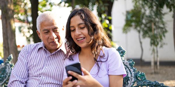 Two people checking a phone alert