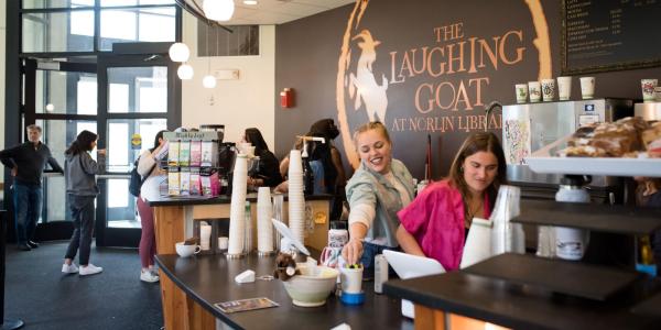 Students working in Laughing Goat coffee shop inside Norlin Library