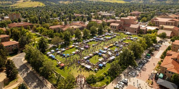 Tables and campus community members fill Farrand Field during the Be Involved Fair