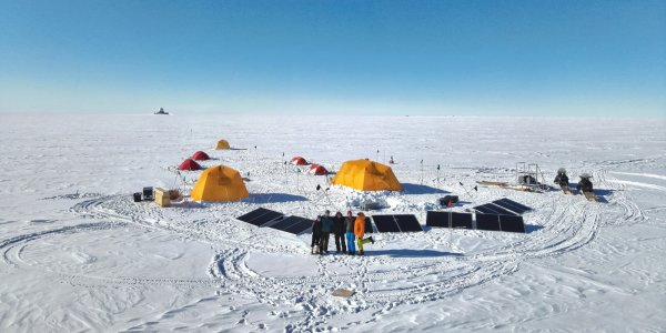 Group of researchers and tents on ice in Greenland
