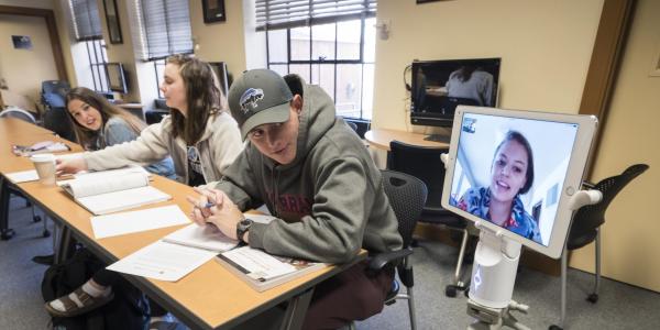 Students using a Kubi device for distance learning