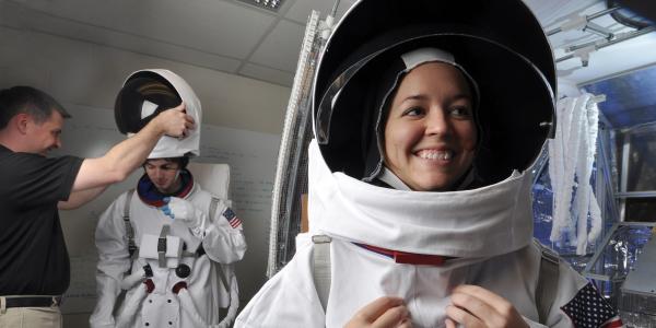 Students wearing space suits 