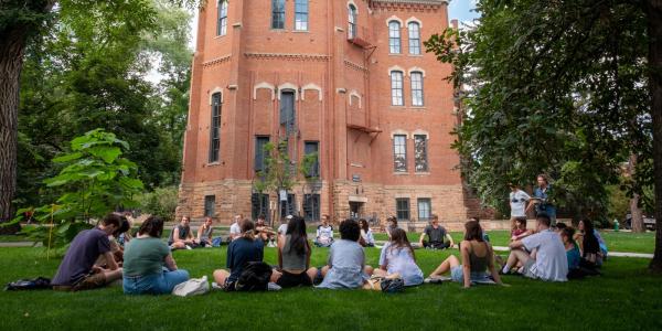 students sitting in a circle for an outdoor class