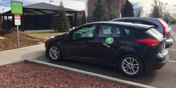 A Zipcar is parked on campus.