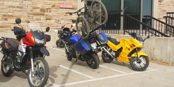 motorcyles parked outside a campus building