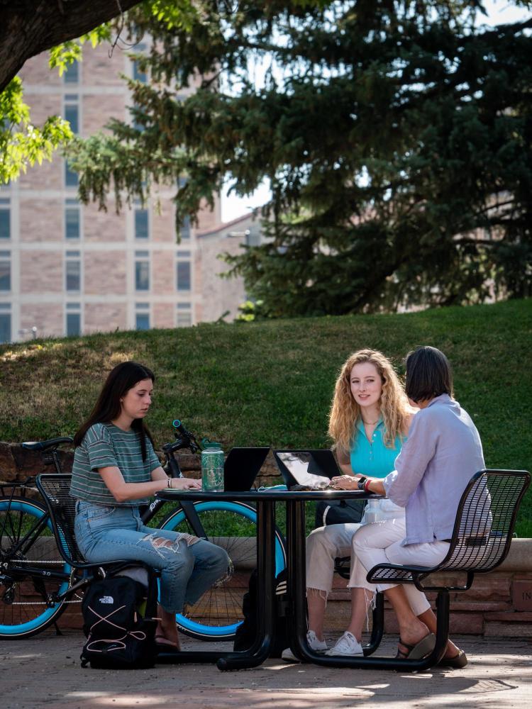 Students sitting at a table and talking