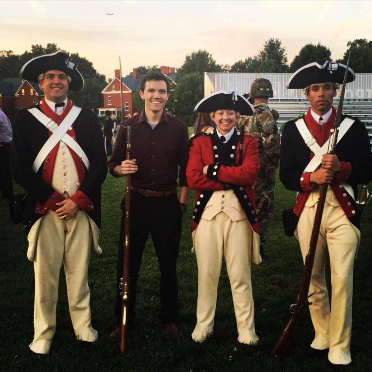 Dylan Rogers poses with Revolutionary War re-enactors