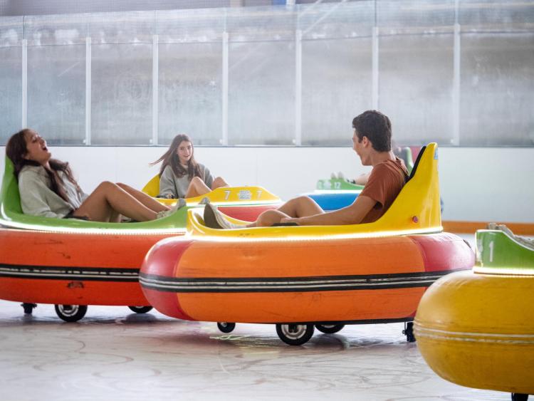 Students ride bumper cars on the Rec Center ice rink