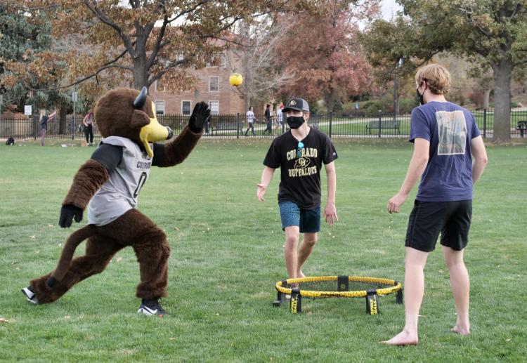 Buffalo mascot Chip playing lawn games with students