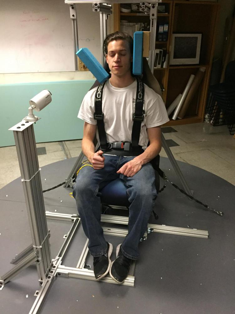 Test subject sitting in artificial gravity simulator