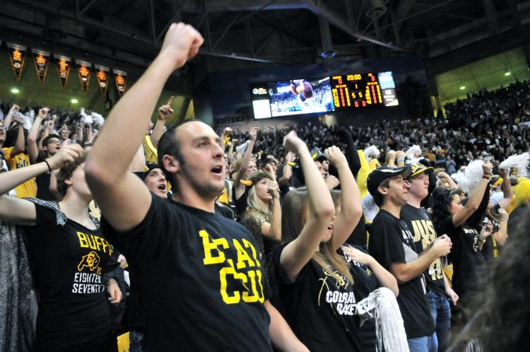 Buffs fans cheer at a men's basketball game CSU