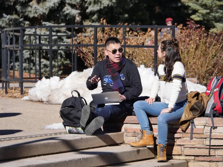 Students sitting on campus talking