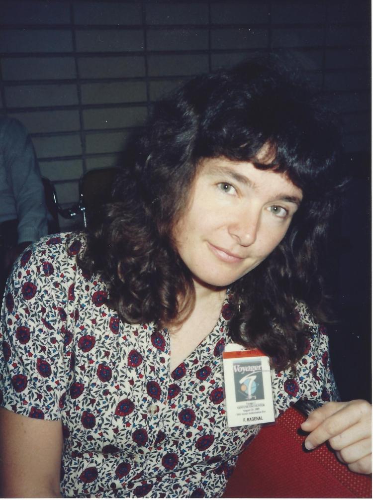 Headshot of woman wearing a badge that says "Voyager"