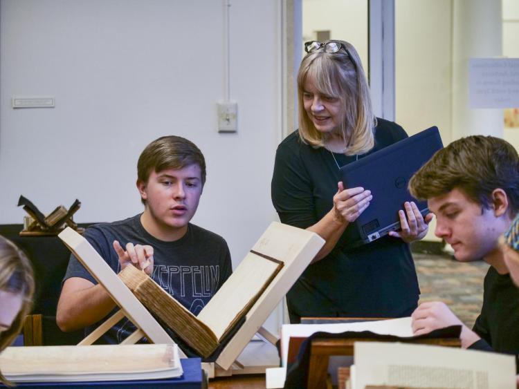 Students in HIST 1113 Honors Seminar examine rare books and pamphlets at the Norlin Library Special Collections