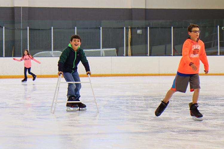 Families ice skating at the CU Boulder Rec Center Ice Rink