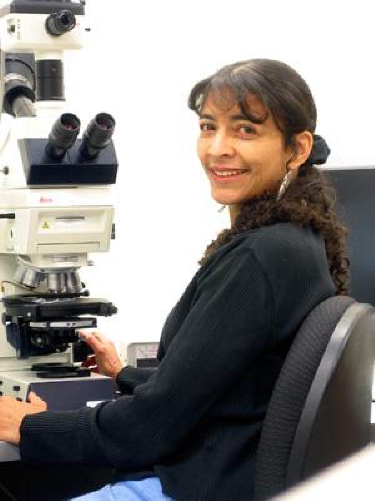 Karen Chin sitting in front of microscope