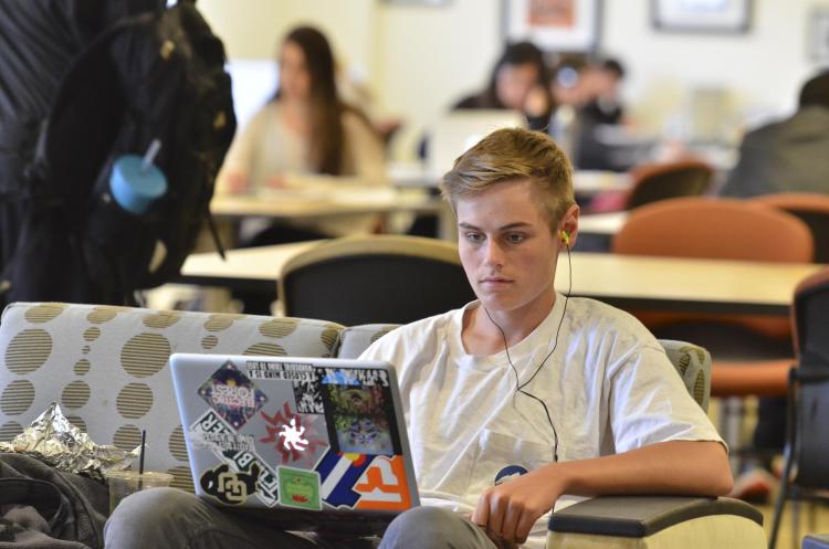 Student on laptop at Leeds School of Business library