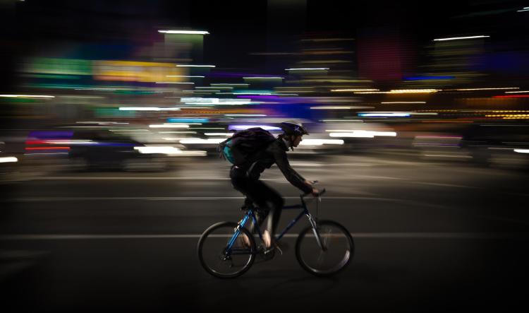 person riding bike at night with no lights