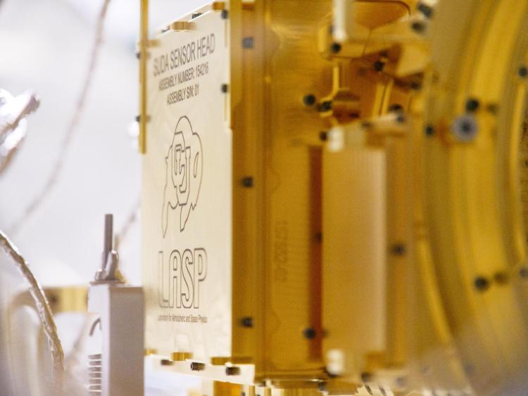 CU Boulder's Ralphie logo on the side of a gold scientific instrument