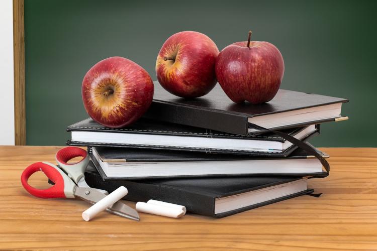 Books and apples on desk