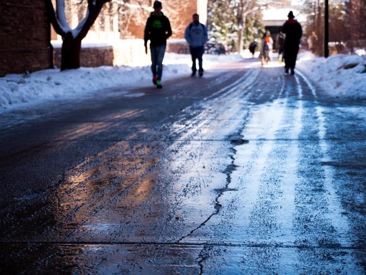 Students walk down snow-cleared roadway