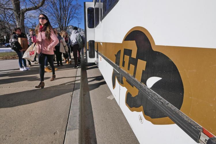 Students exit a Buff Bus on campus