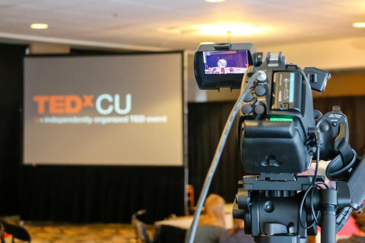 Video camera pointed at TEDxCU screen