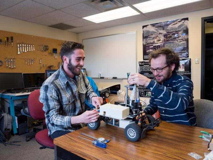 Two students with their telerobotic model