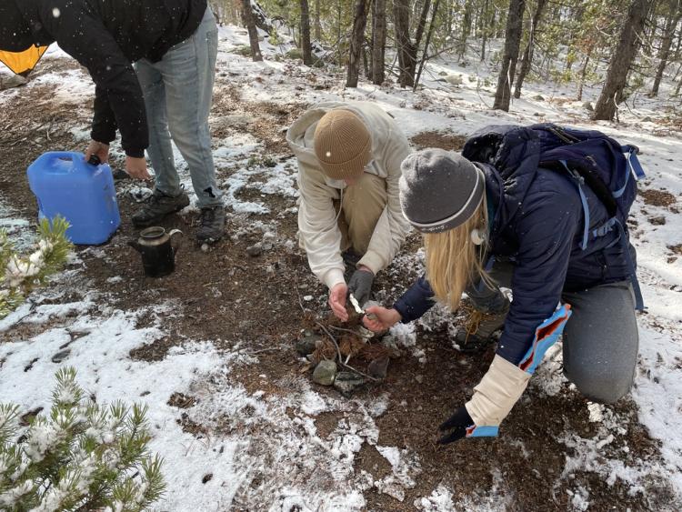 Students build a fire during leadership course