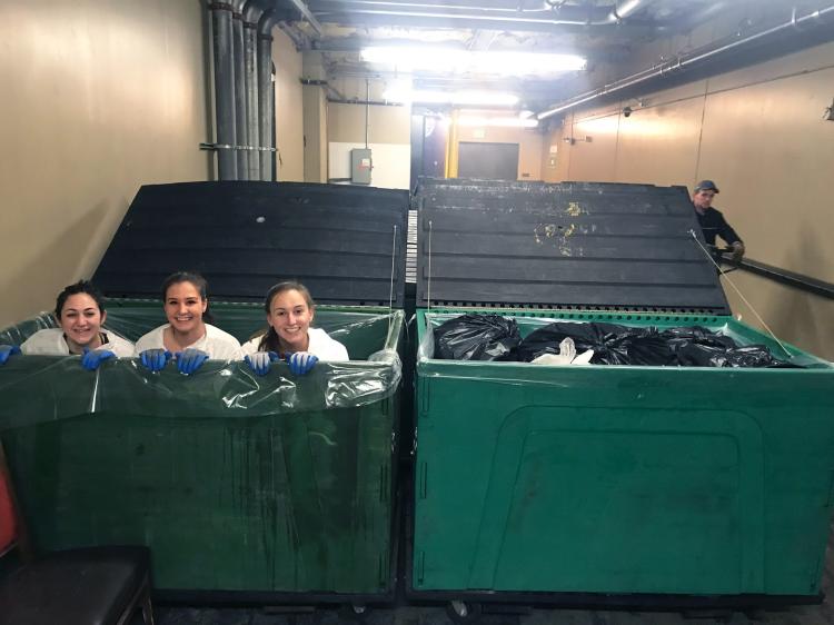 Students pose for photo in recycling bins at Vail Resorts