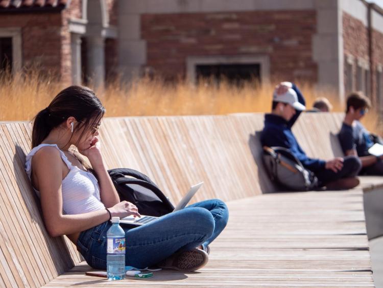 Student studying outside on a warm day