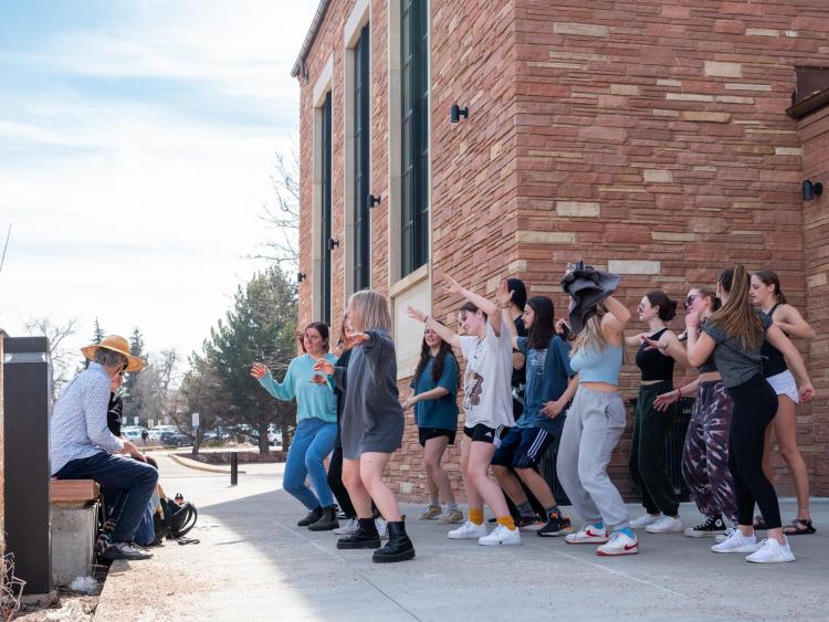 Students dancing outside on campus