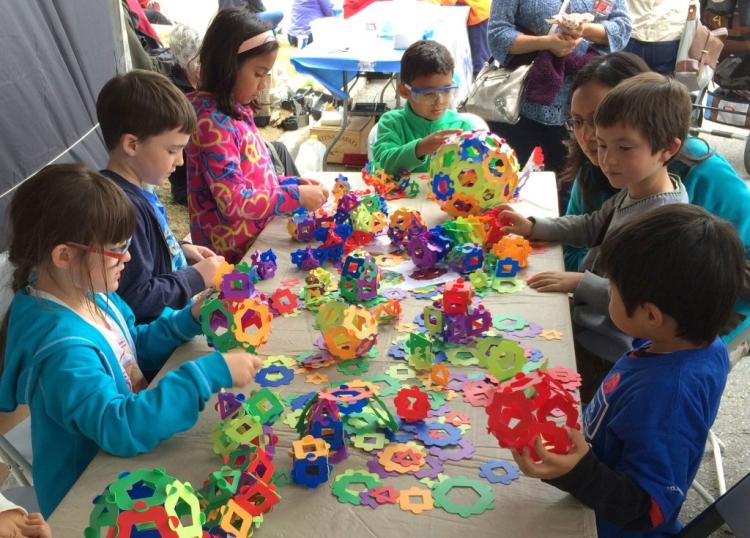 Children creating colorful paper sculptures