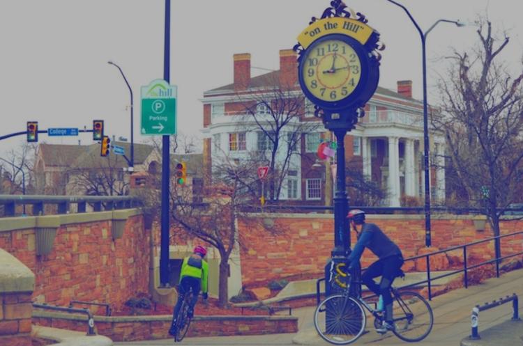 Cyclists approaching the underpass on The Hill, with the Hill clock in the foreground