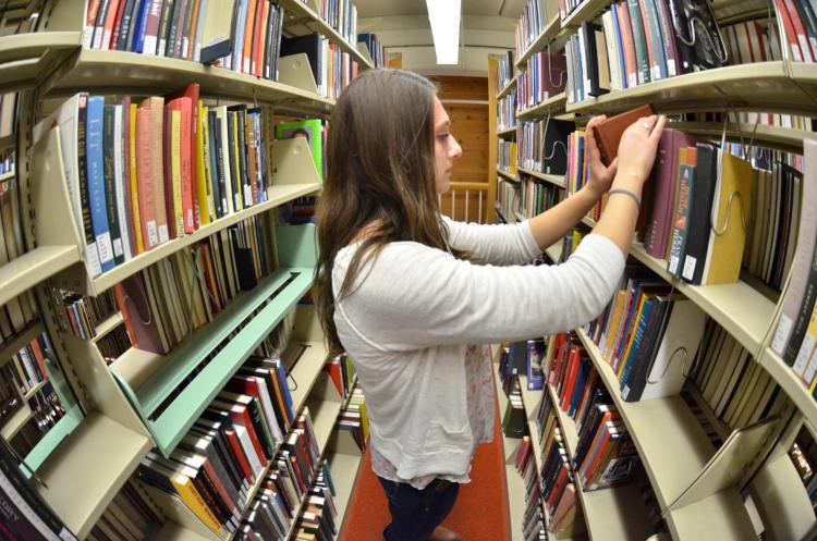 Filing books in the stacks in Norlin Library
