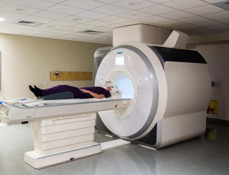A research subject is ready to enter an  MRI.