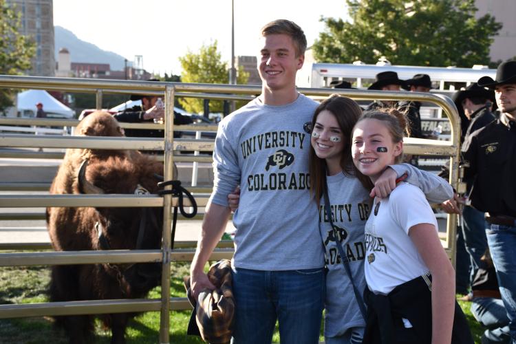 Buffs fans standing next to Ralphie the Buffalo