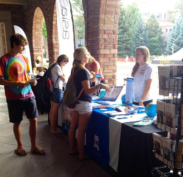 Students visit the Semester at Sea table at the Study Abroad Fair
