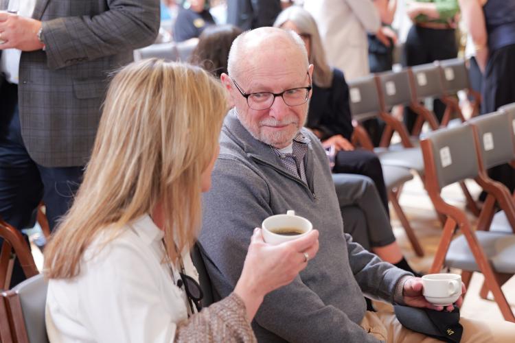 Provost Russell Moore chats with a colleague before the State of the Campus address
