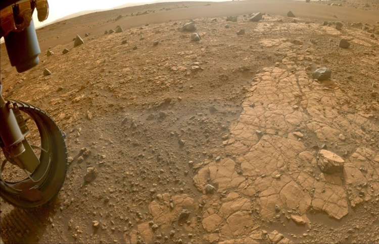 Photo of a wheel and a dusty landscape