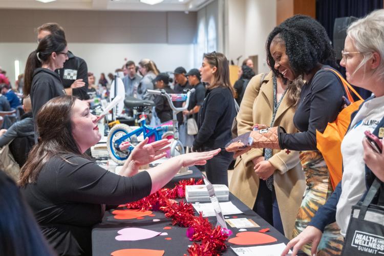 Senior Vice Chancellor Janel Forde visits a booth at the Health and Wellness Fair