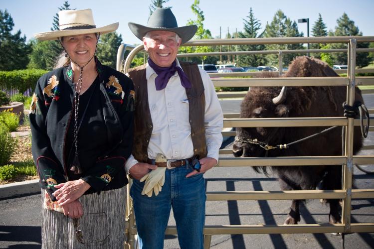 Jeanne and Tom Baur post with a buffalo